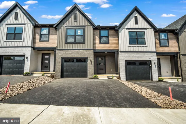a front view of a house with yard