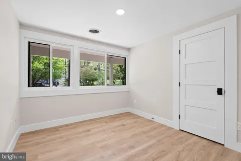 a living room with furniture window and a wooden floor