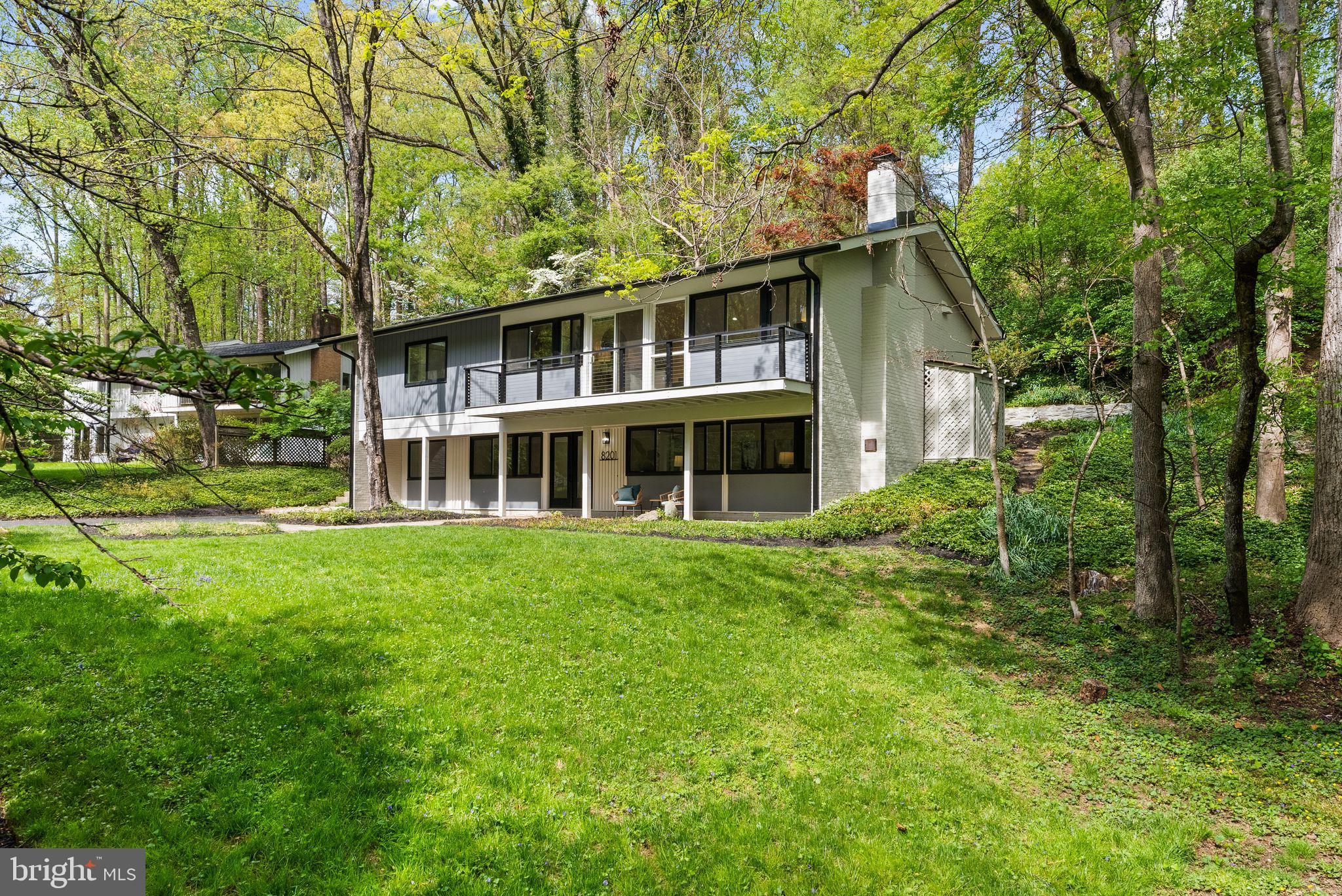 8201 Hamilton Spring Court Bethesda, MD 20817 - Photo 4 of 66 a front view of a house with a garden