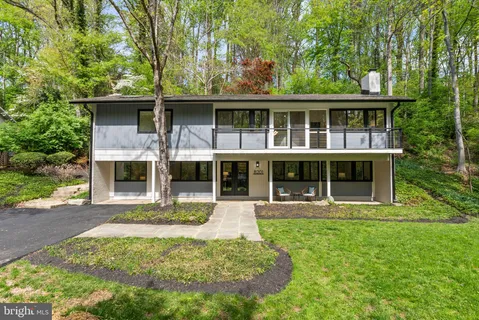 a front view of house with yard and outdoor seating