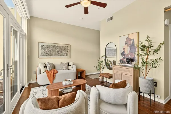 a living room with furniture and a chandelier