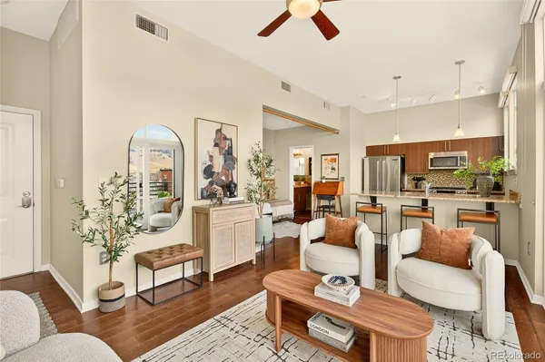 a living room with furniture a rug and a chandelier