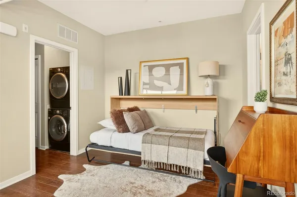 a bedroom with a bed and wooden floor