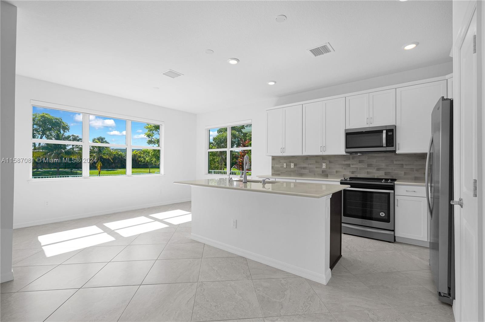 1595 Trailhead Terrace Hollywood, FL 33021 - Photo 14 of 49 a kitchen with granite countertop a stove and a refrigerator