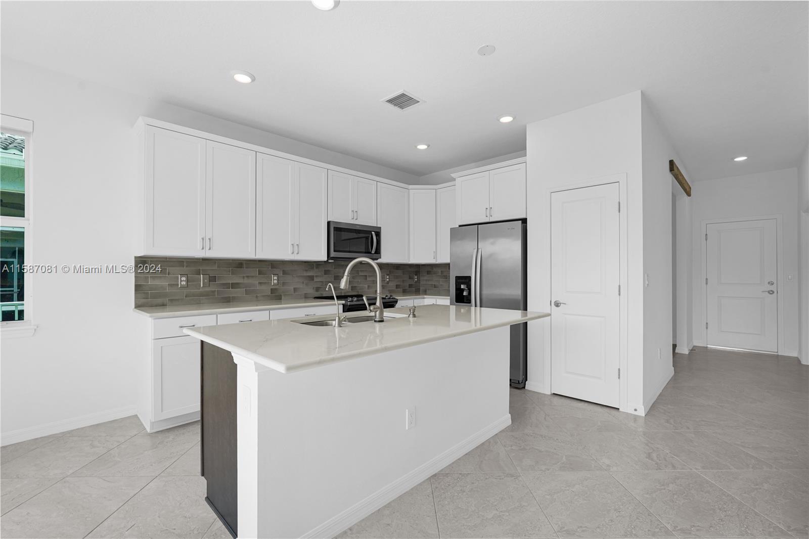 1595 Trailhead Terrace Hollywood, FL 33021 - Photo 16 of 49 a kitchen with a sink a refrigerator and cabinets