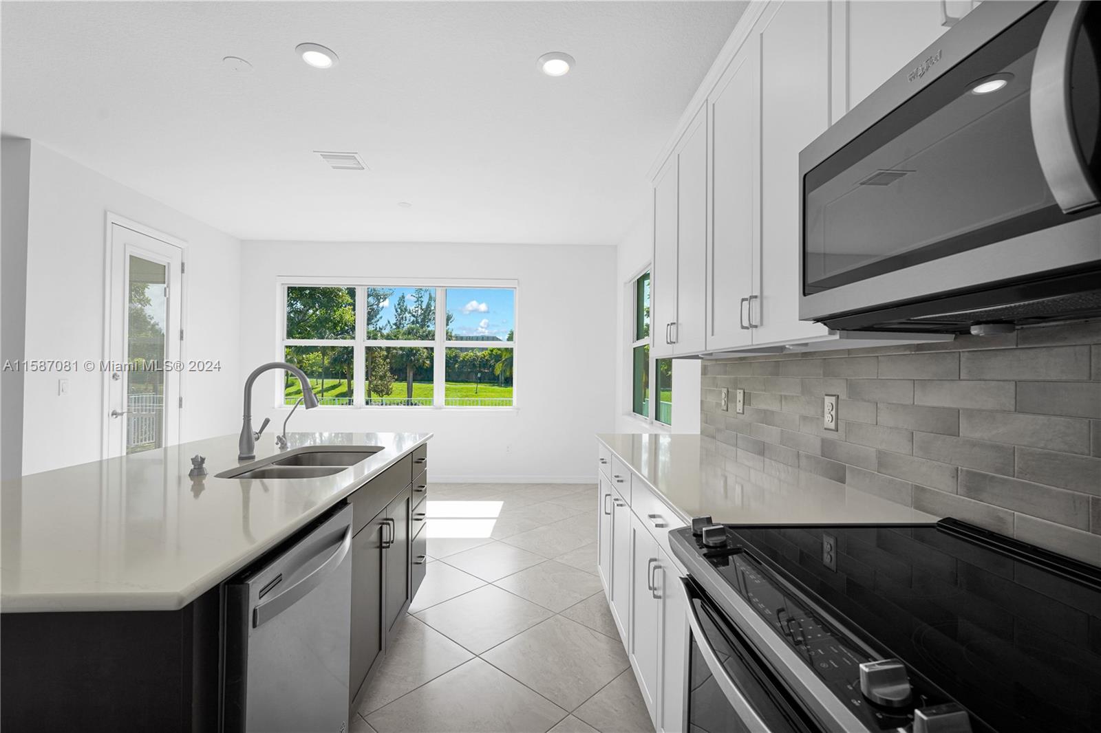 1595 Trailhead Terrace Hollywood, FL 33021 - Photo 17 of 49 a kitchen with sink a microwave a stove and cabinets