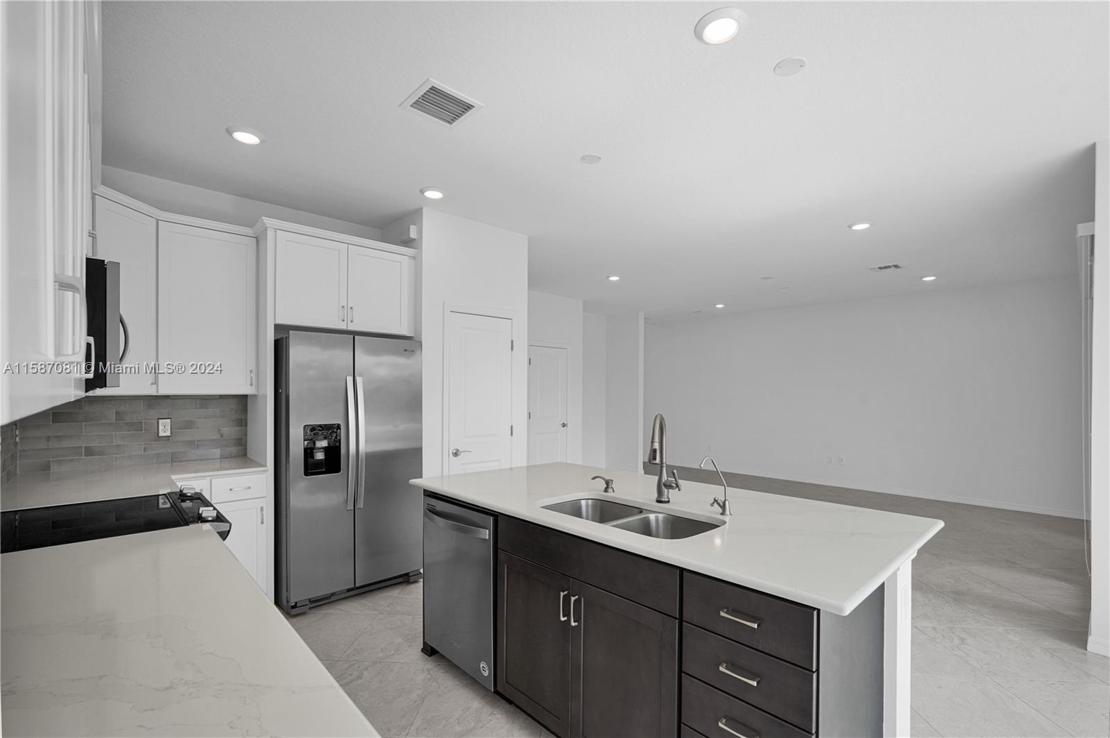 1595 Trailhead Terrace Hollywood, FL 33021 - Photo 20 of 49 a kitchen with a sink refrigerator and cabinets