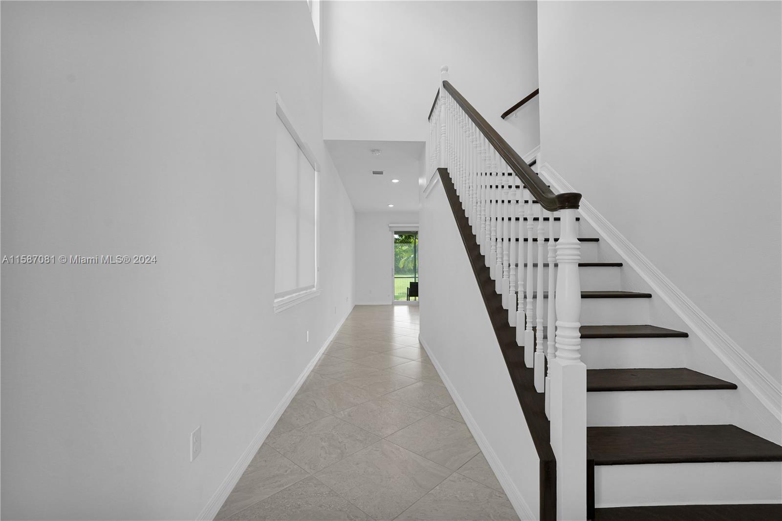 1595 Trailhead Terrace Hollywood, FL 33021 - Photo 27 of 49 a view of staircase with wooden floor and white walls