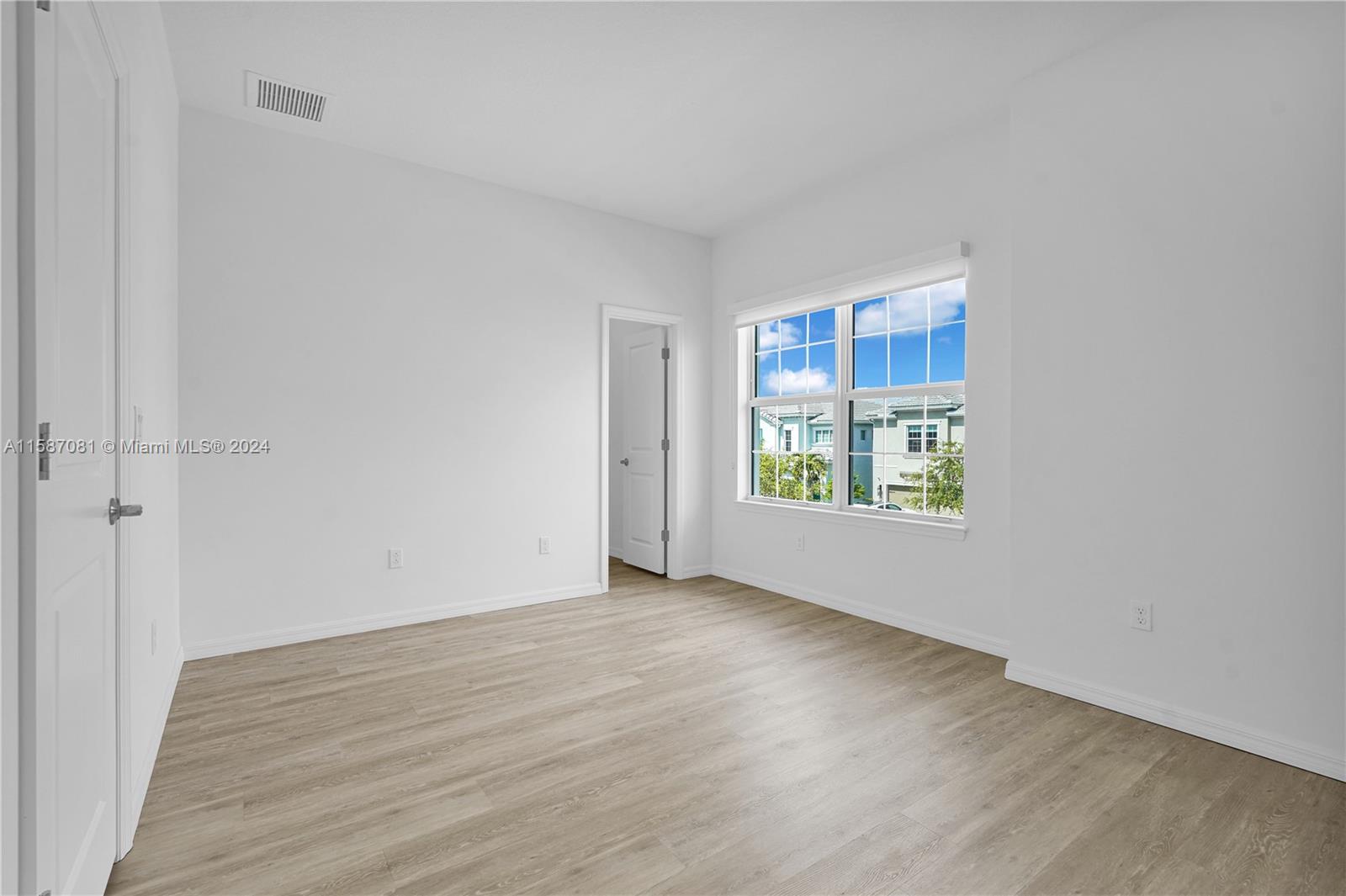 1595 Trailhead Terrace Hollywood, FL 33021 - Photo 33 of 49 a view of an empty room with wooden floor and a window