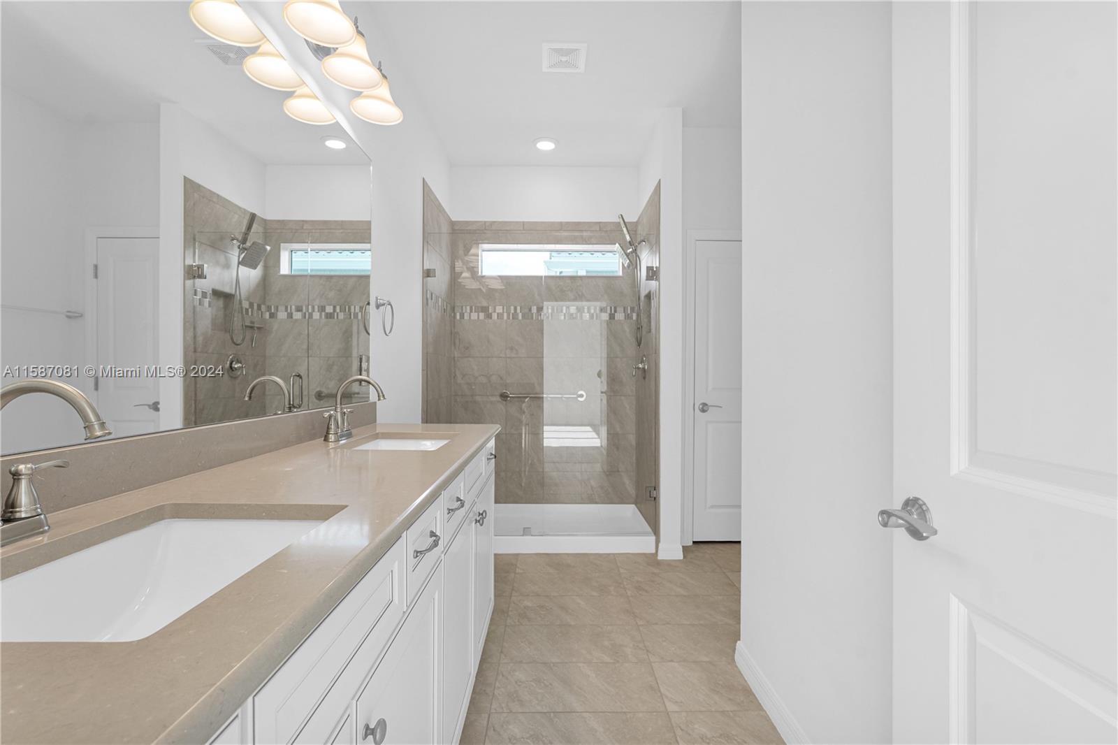 1595 Trailhead Terrace Hollywood, FL 33021 - Photo 34 of 49 a spacious bathroom with a double vanity sink a mirror and a bathtub