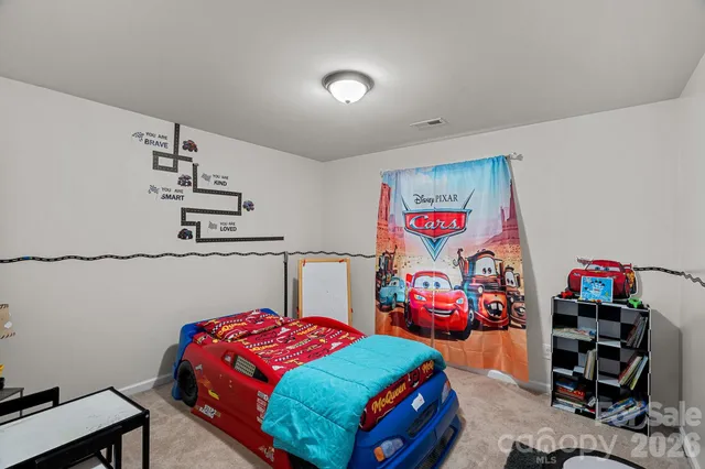 a bedroom with a bed and a bookshelf