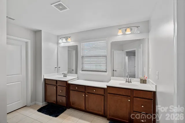 a bathroom with a double vanity sink and a mirror