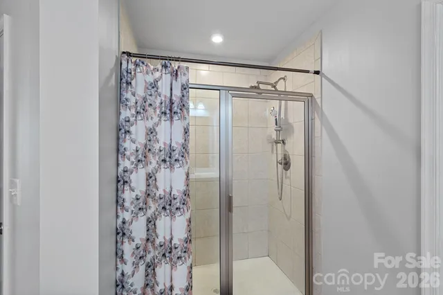 a bathroom with a shower curtain and a shower curtain