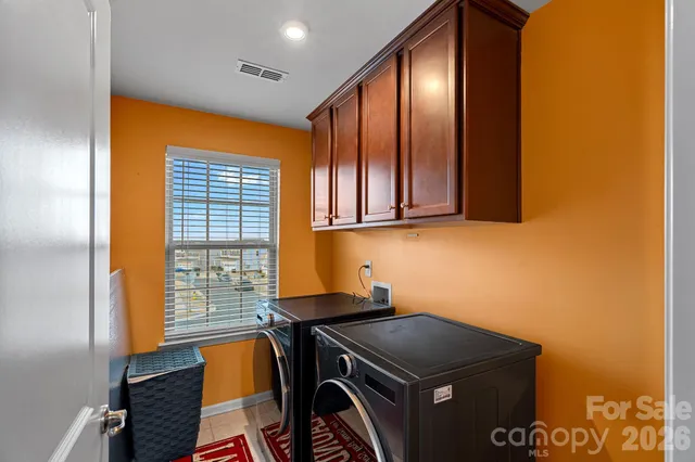 a kitchen with a sink a refrigerator and cabinets