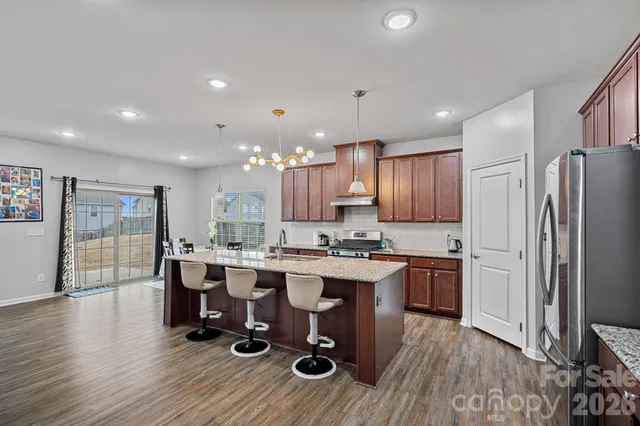 a kitchen with lots of counter space and stainless steel appliances