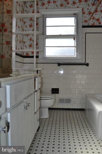 7915 Ruxway Road Towson, MD 21204 - Photo 11 of 14 a bathroom with a sink a toilet and a window