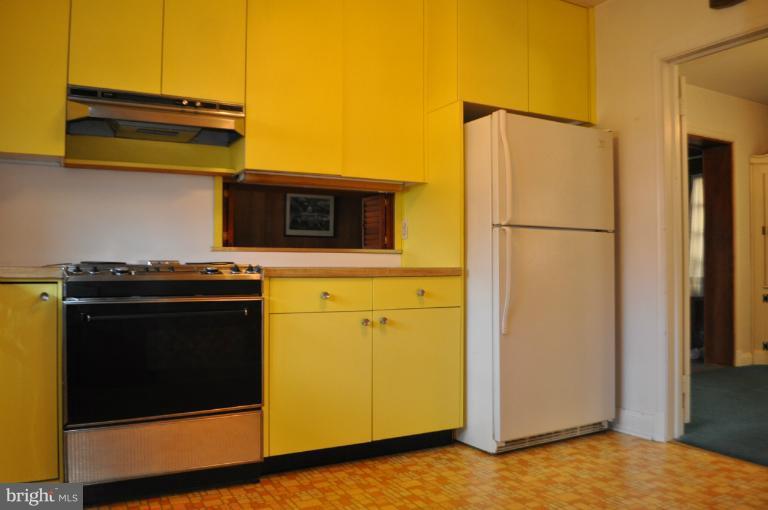 7915 Ruxway Road Towson, MD 21204 - Photo 12 of 14 a kitchen with a refrigerator and a stove top oven