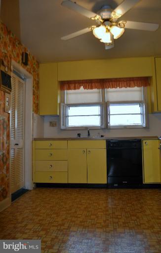 7915 Ruxway Road Towson, MD 21204 - Photo 13 of 14 a view of a kitchen with a sink cabinets and a window