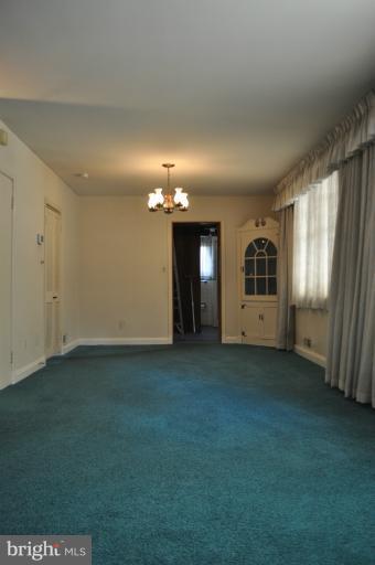7915 Ruxway Road Towson, MD 21204 - Photo 7 of 14 an empty room with windows and fireplace