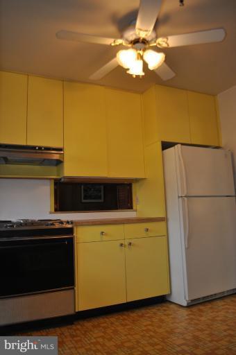 7915 Ruxway Road Towson, MD 21204 - Photo 9 of 14 a kitchen with a stove and a refrigerator