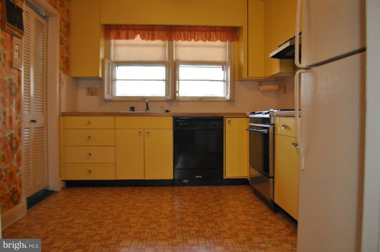 7915 Ruxway Road Towson, MD 21204 - Photo 10 of 14 a view of a kitchen with wooden floor and windows