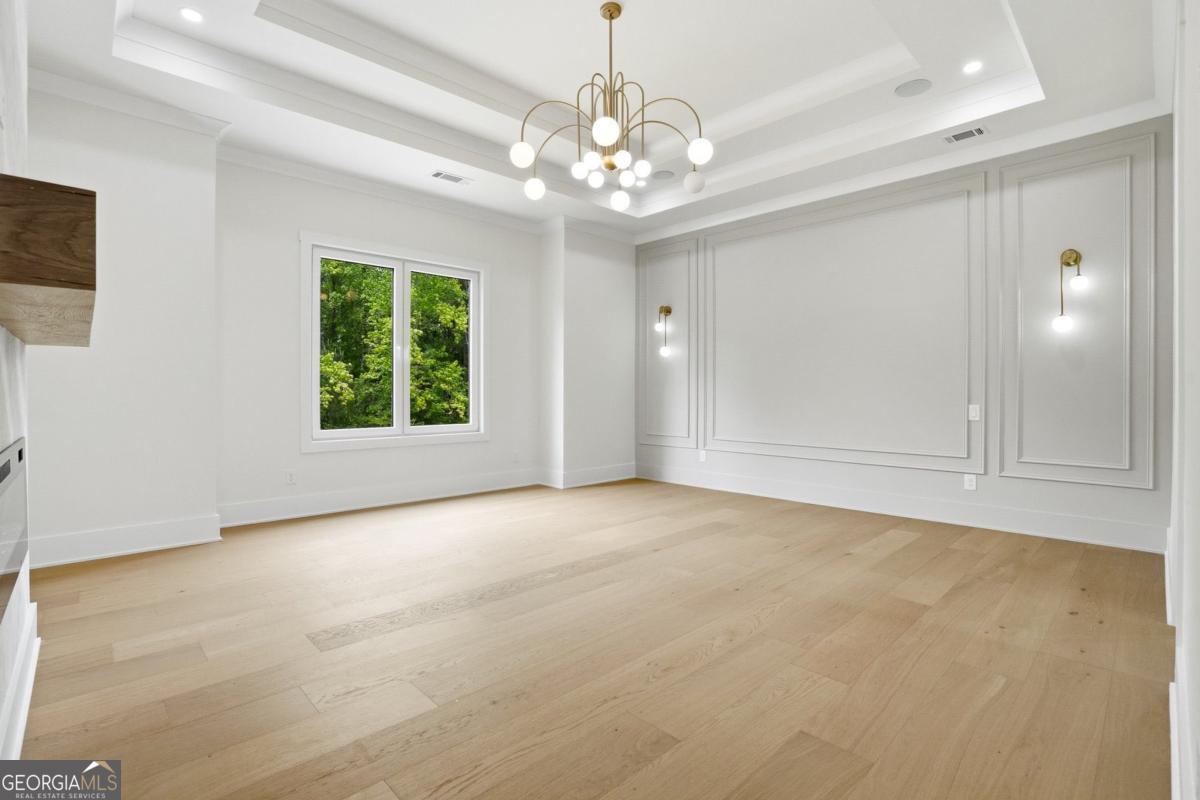 1557 Whitley Road Dacula, GA 30019 - Photo 16 of 46 a view of an empty room with window and chandelier fan
