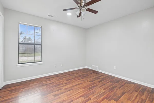 wooden floor in an empty room with a window