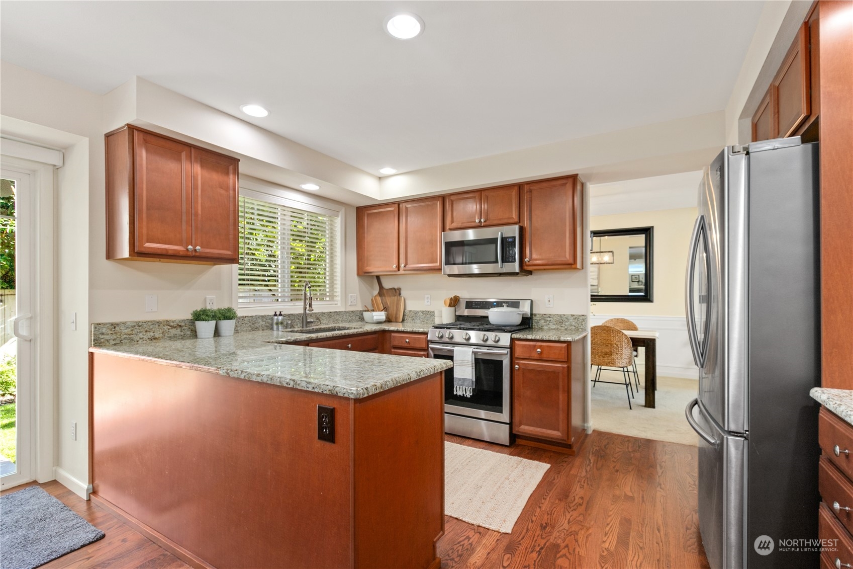 18205 27th Drive Southeast Bothell, WA 98012 - Photo 12 of 37 a kitchen with stainless steel appliances granite countertop a sink stove and refrigerator
