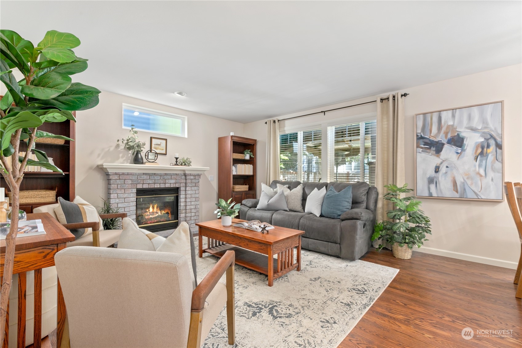 18205 27th Drive Southeast Bothell, WA 98012 - Photo 16 of 37 a living room with furniture a fireplace and a potted plant