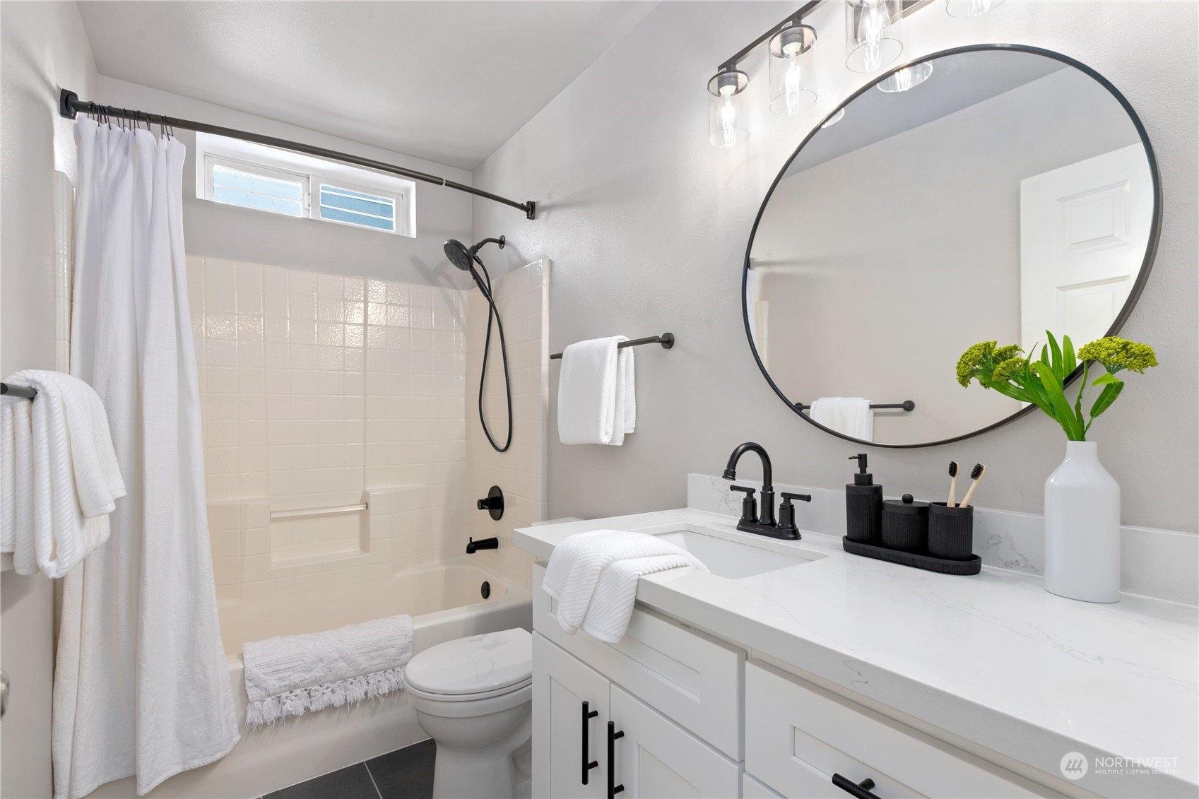 18205 27th Drive Southeast Bothell, WA 98012 - Photo 30 of 37 a bathroom with a granite countertop sink a toilet and a mirror
