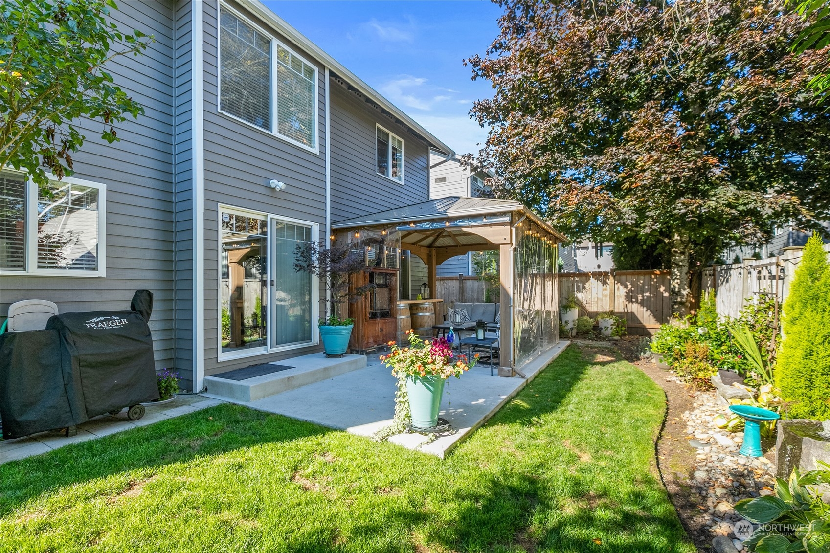 18205 27th Drive Southeast Bothell, WA 98012 - Photo 32 of 37 a view of a house with a yard and potted plants
