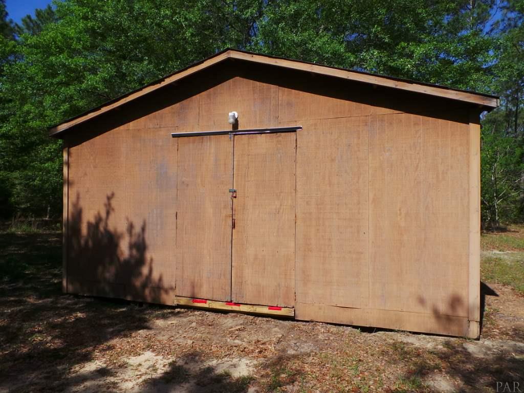 5049 Bodega Road Milton, FL 32583 - Photo 9 of 23 a backyard of a house with lots of green space