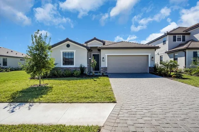 a front view of a house with a yard and garage
