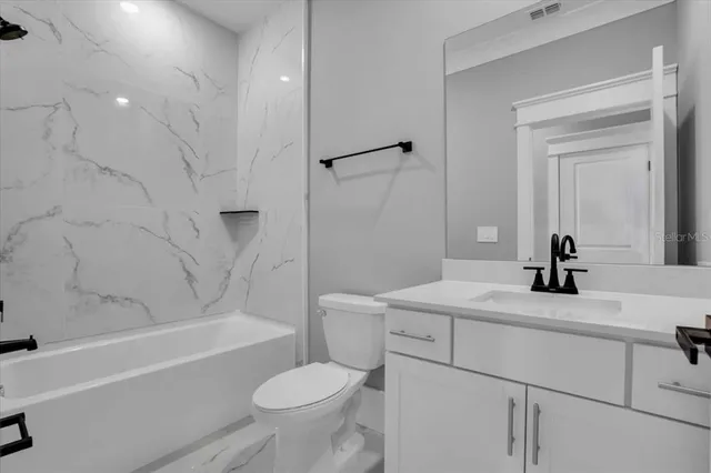 a bedroom with a large bed and dresser