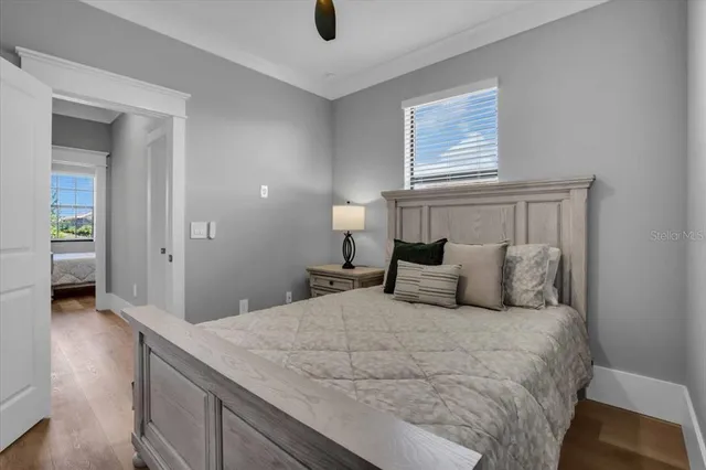 a bedroom with a bed and a flat tv screen on dresser