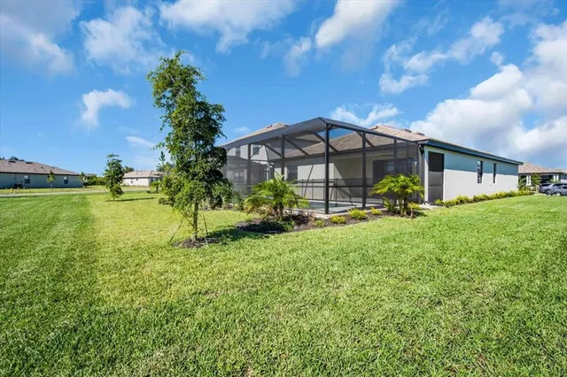 an aerial view of a house with swimming pool having outdoor seating