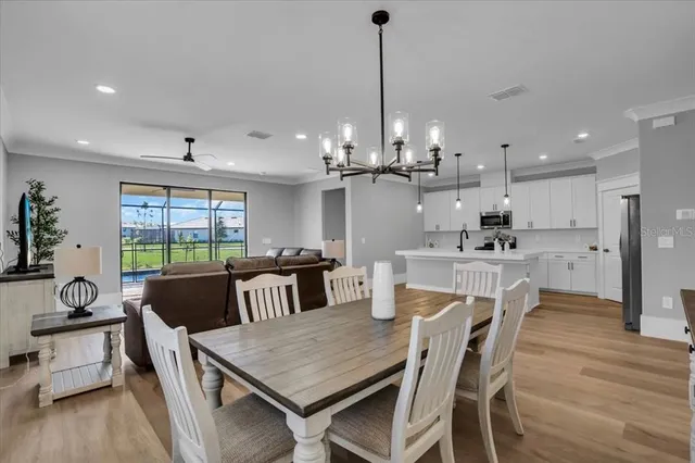 a living room with furniture plant and a large window