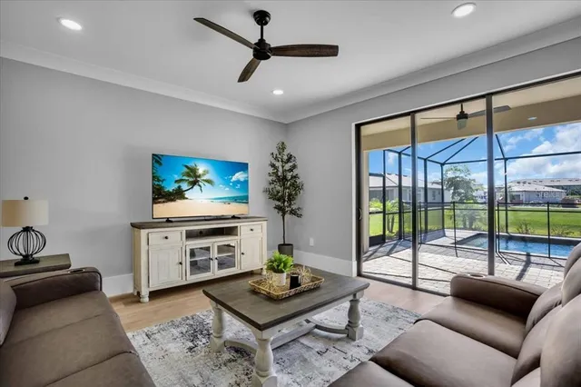 a living room with furniture and a chandelier
