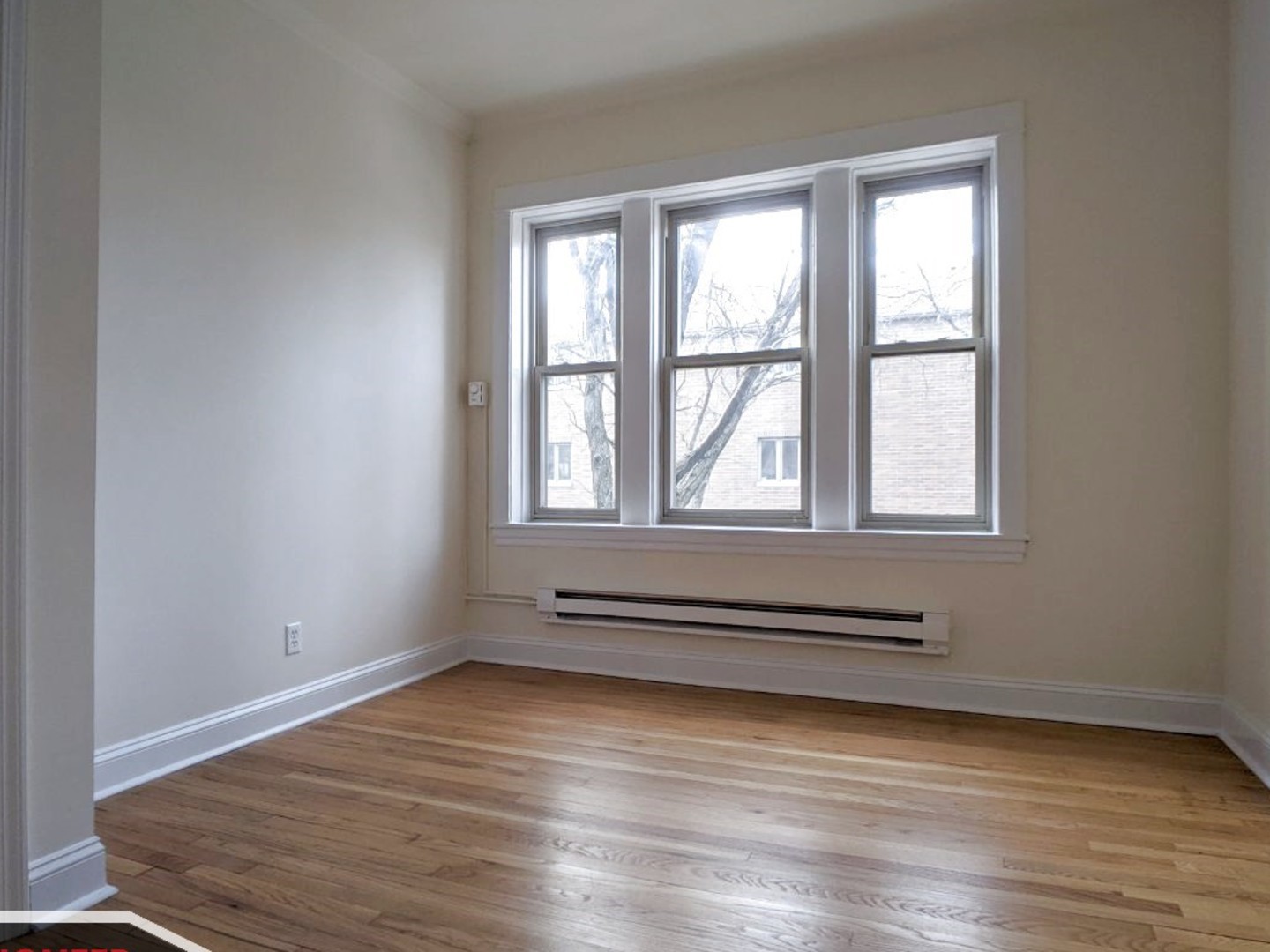 2919 West George Street, Unit 2 Chicago, IL 60618 - Photo 8 of 14 wooden floor in an empty room with a window