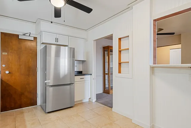 a kitchen with cabinets stainless steel appliances and a counter space