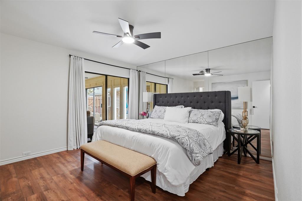 6500 Spur Ranch Court Plano, TX 75023 - Photo 11 of 32 a bedroom with a bed and wooden floor