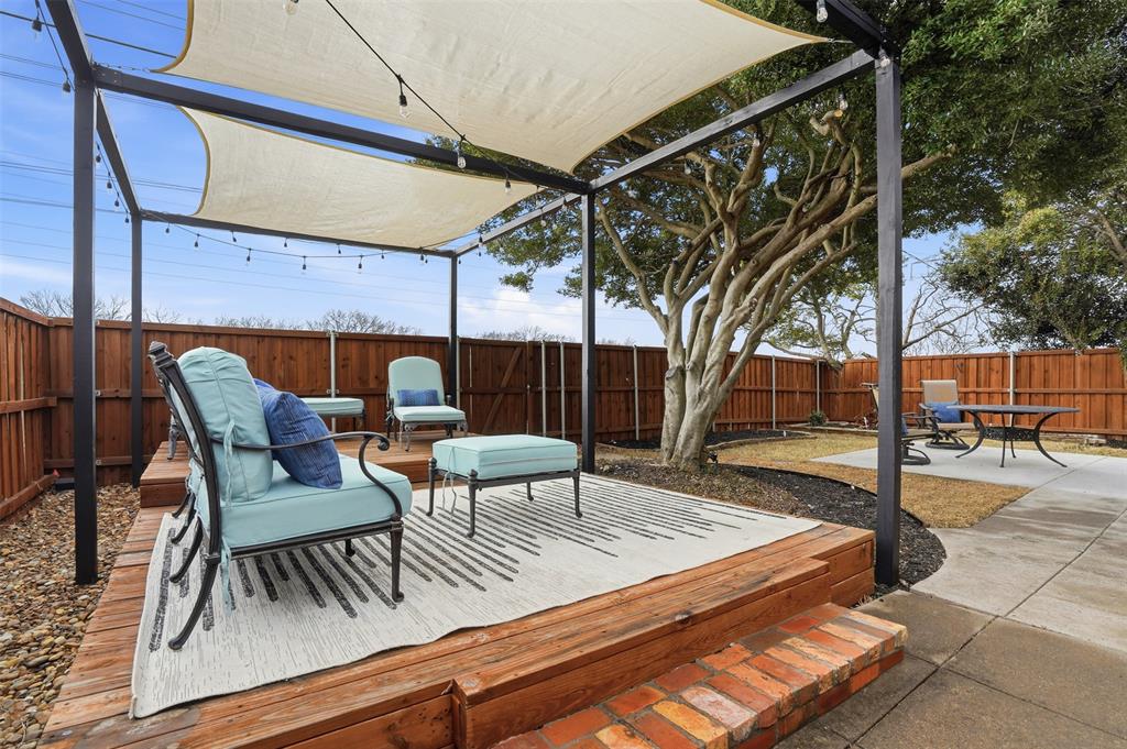 6500 Spur Ranch Court Plano, TX 75023 - Photo 22 of 32 a view of a patio with a table and chairs