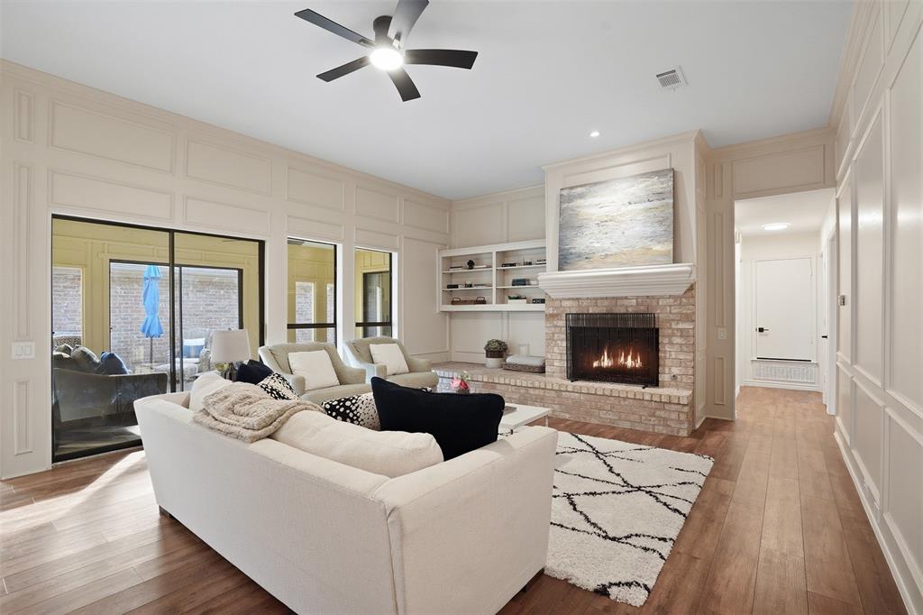 6500 Spur Ranch Court Plano, TX 75023 - Photo 3 of 32 a living room with furniture and a fireplace