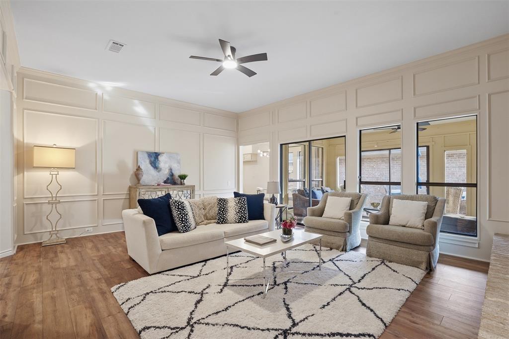 6500 Spur Ranch Court Plano, TX 75023 - Photo 4 of 32 a living room with furniture and wooden floor