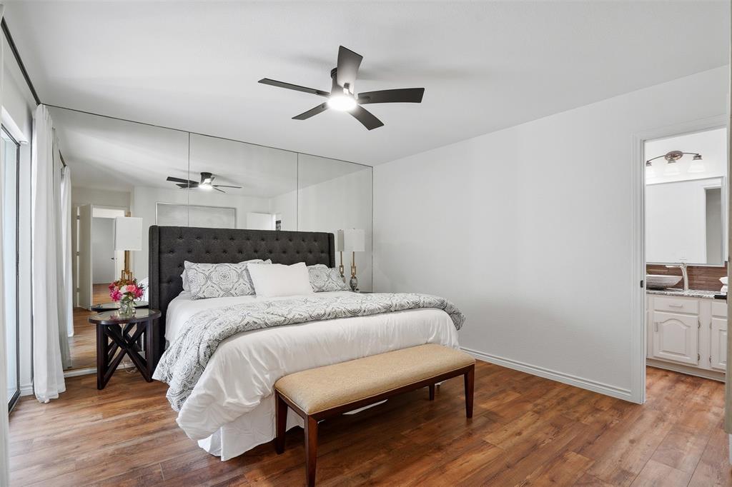 6500 Spur Ranch Court Plano, TX 75023 - Photo 9 of 32 a bedroom with a bed and wooden floor