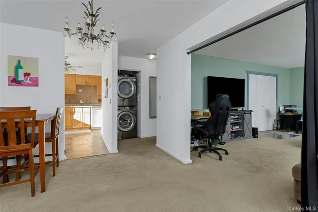 a view of a livingroom with workspace and a window