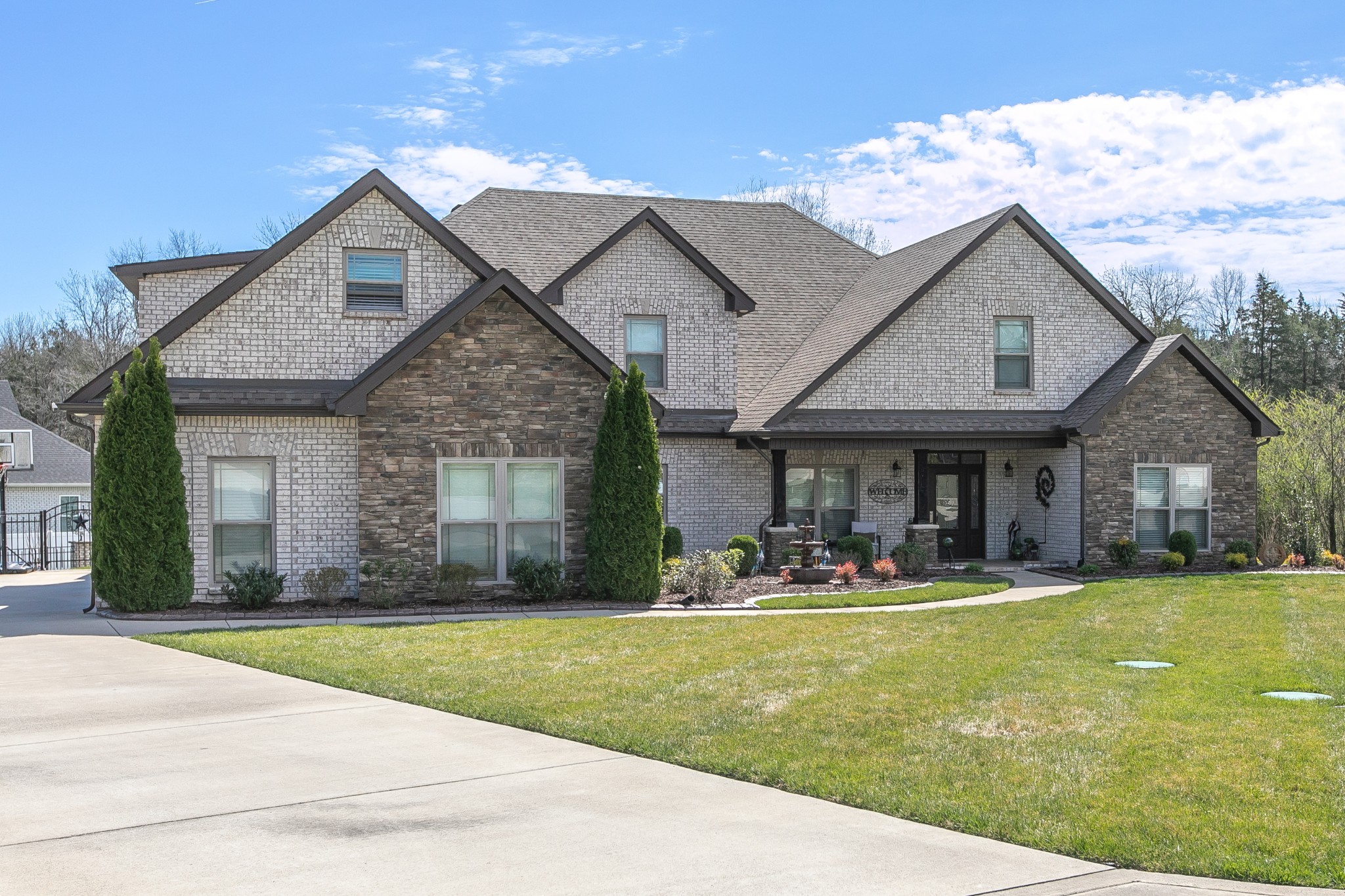 a front view of a house with a yard and garage