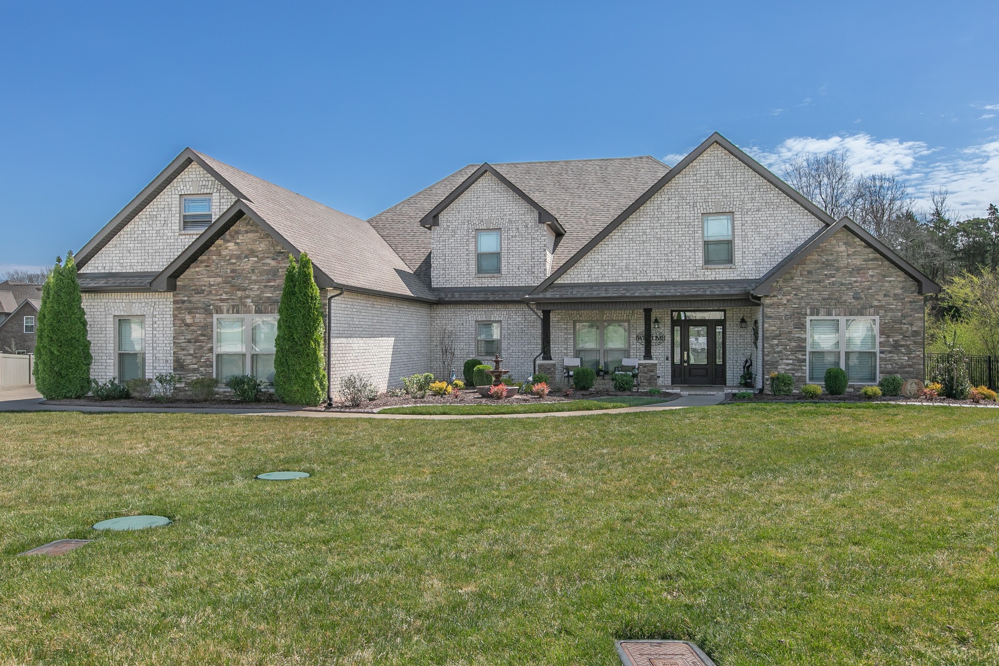 7745 Santos Drive Murfreesboro, TN 37129 - Photo 2 of 58 a front view of a house with a garden and porch