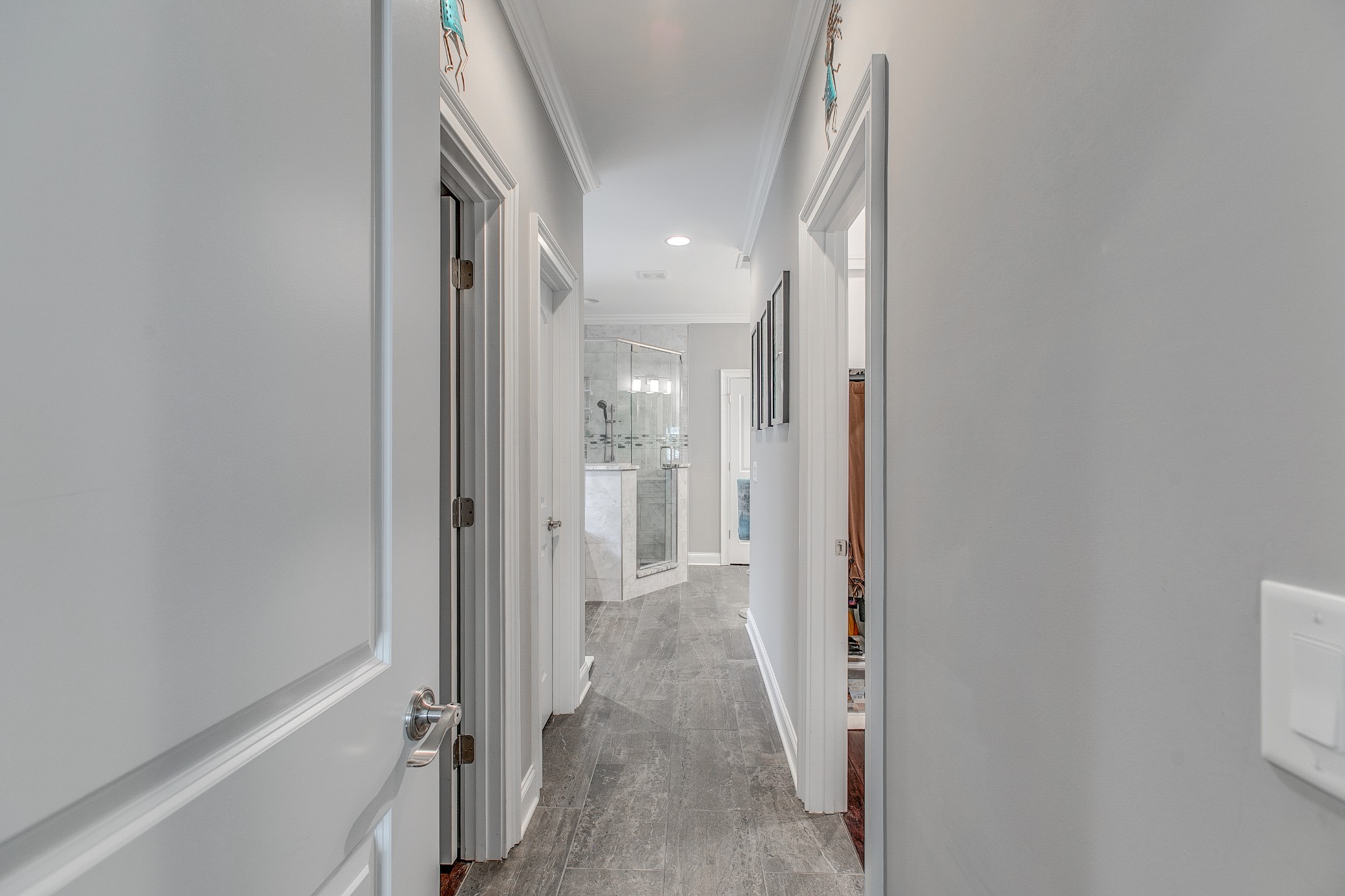 7745 Santos Drive Murfreesboro, TN 37129 - Photo 27 of 58 a view of a hallway with wooden floor and a bathroom