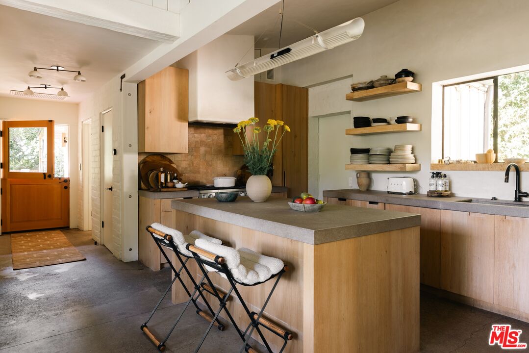 1830 Old Orchard Road Los Angeles, CA 90049 - Photo 6 of 30 a kitchen with a sink cabinets and window